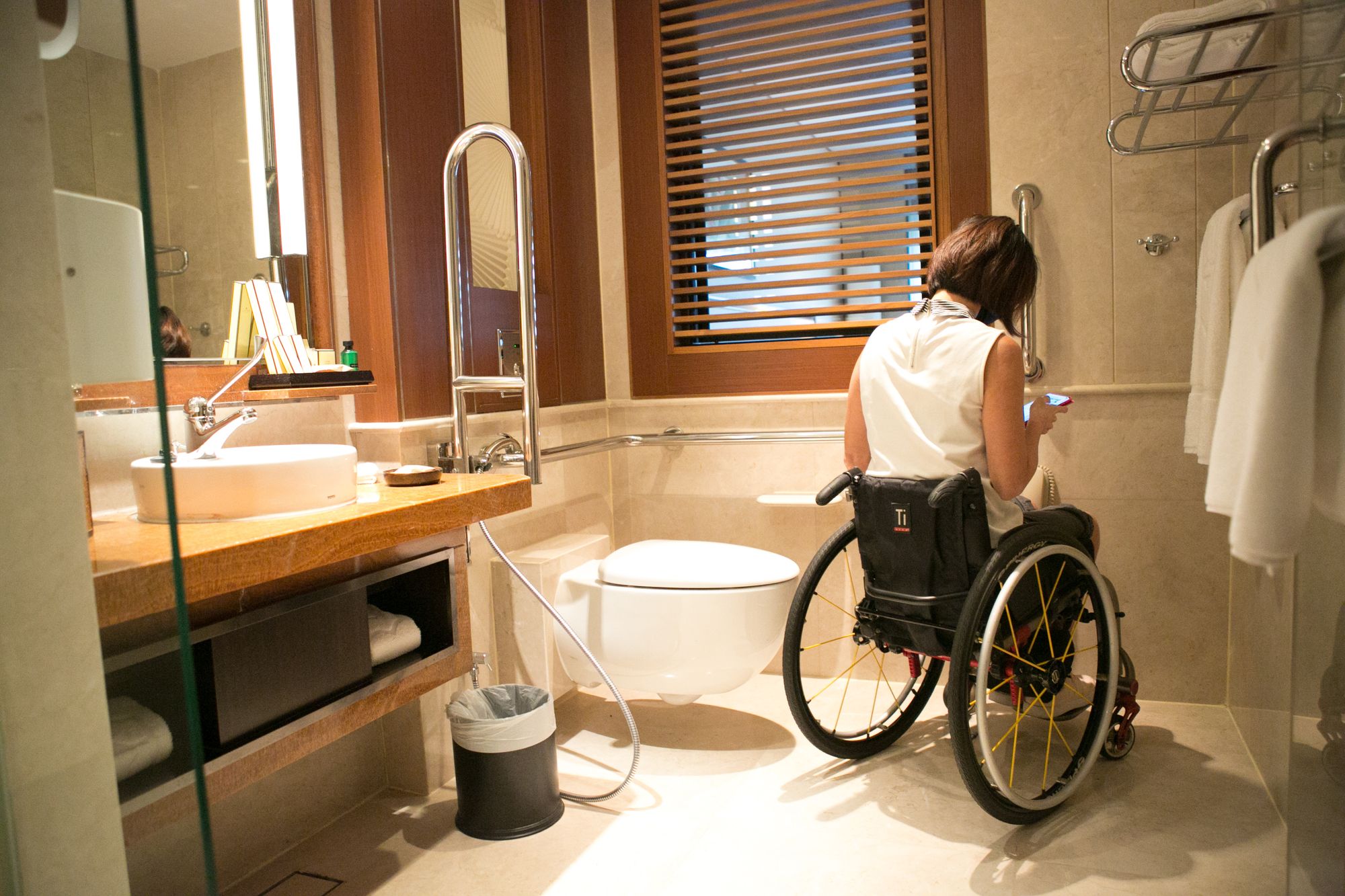 image of woman in wheelchair in hotel bathroom